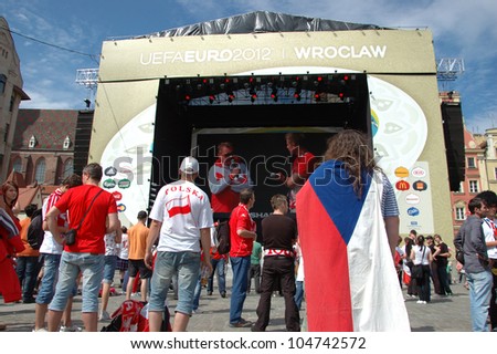 WROCLAW, POLAND - JUNE 8: Unidentified Czech and Polish fans watch show on stage Euro 2012 on June 8, 2012 in Wroclaw. The EURO 2012 will be held from June 8 - July 1, 2012 hosted by Poland and Ukrain