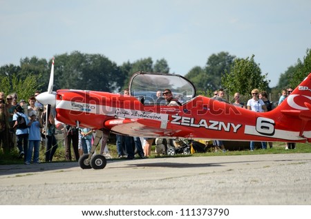 SZYMANOW, POLAND - AUGUST 25: Pilot Tadeusz Kolaszewski lands after the acrobatic show in plane Zlin-50 LS on August 25, 2012 in Szymanow.