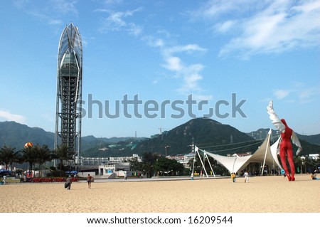 China South Sea, Guangdong province. Shenzhen city - sea side, wide beach with viewing tower at DaMeiSha. Large angels sculptures standing at the beach.