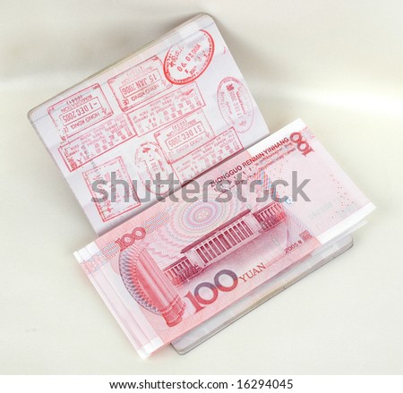 Passport full of stamps from China and Hongkong borders together with Chinese money, RMB banknotes.