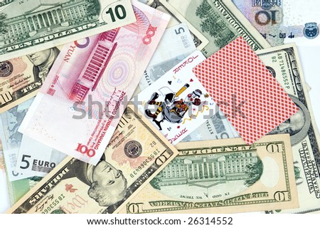 Mixed banknotes as background with two cards - jokers. Photo of different banknotes, money in different shapes and colors. Useful for financial, economic backgrounds.