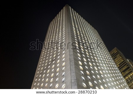 Hongkong, Central - modern skyscraper with special round windows, office\'s building by night.