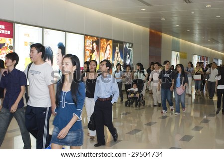 SHENZHEN, GUANGDONG - MAY 1, 2009: Crowds walk by during labor holidays May 1, 2009 in Shenzhen, Guangdong, China. Thousands of Chinese workers try to make use of one day holiday in China.