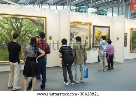 SHENZHEN, GUANGDONG- MAY 16: Visitors admire modern and ancient Chinese art paintings and graphics made in ink at China International Cultural Industries Fair May 16, 2009 in Shenzhen, Guangdong China