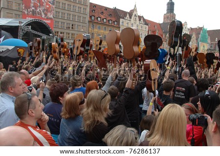 WROCLAW, POLAND - APRIL 30: Guitars World Guinness Record, 5601 participants gather in front of Wroclaw\'s Town Hall on April 30, 2011 to beat guitar mass participation record in Wroclaw, Poland.