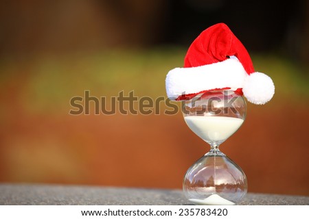 Christmas countdown. Modern Hourglass -- sand trickling through the bulbs of a crystal sand glass.