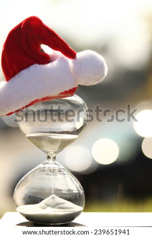 Christmas countdown. Modern Hourglass -- sand trickling through the bulbs of a crystal sand glass.