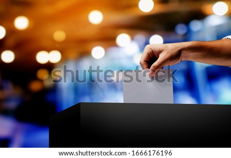 Hand holding ballot paper for election vote concept.Vote is very important for our nation.Everyone do the Vote.