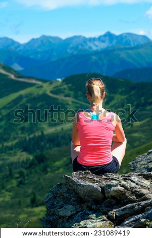Young woman tourist have a rest at the mountains.