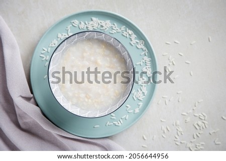 Congee is a type of rice porridge or gruel popular in many Asian countries.Rice porridge in bowl. Copy space. Photo stock © 