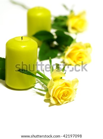 candles and yellow roses isolated on white background