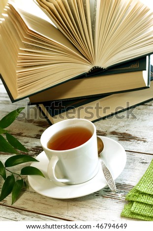 cup of tea and books on wooden
