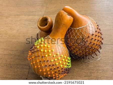 Originated in south west of Nigeria, shekere is a West African percussion instrument consisting of a dried gourd with beads or cowries woven into a net covering the gourd. Photo stock © 