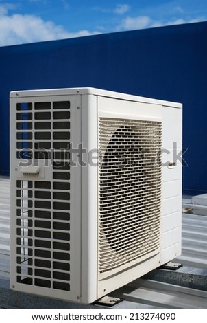 Air Conditioner units on the roof of an industrial building. Blue sky in the background. No people. Copy space.