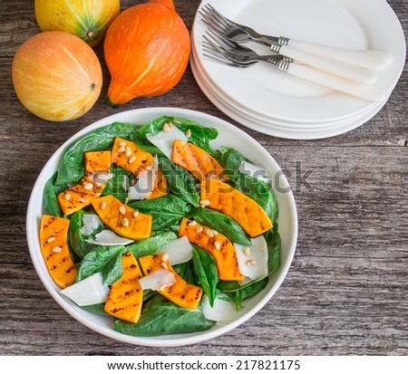 spinach salad with roasted pumpkin, pine nuts and cheese