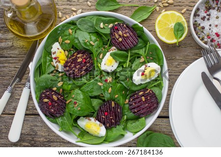 Fresh spinach salad, eggs and roasted beets with flax and sunflower seeds