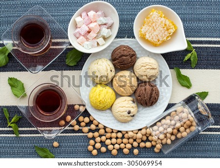 Turkish tea and sweets, shortbread, Turkish delight, honey and roasted chickpeas. soft focus