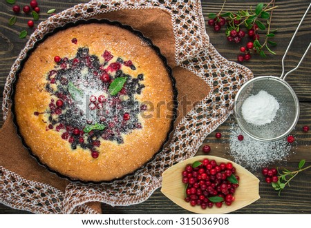 Sponge cake with berries - cranberries and blueberries. Pie. Rustic style. Shallow depth of field