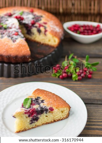 Sponge cake with berries - cranberries and blueberries. Rustic style. Selective focus