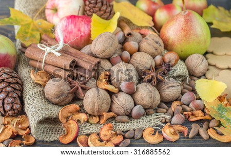 Autumn composition of fruits, nuts and spices - apples, pears, walnuts, pine nuts, hazelnuts, cinnamon and star anise. Selective focus