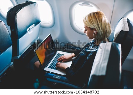 Similar – Image, Stock Photo young woman in airplane. Female tourist sitting by the open airplane window at sunset. People traveling by airplane, transportation, vacation concept.