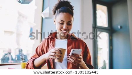Similar – Image, Stock Photo Black woman sending a message on smartphone near sea in sunset