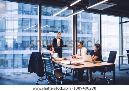 Professional financial experts collaborating during brainstorming meeting listening information from clever female director, businesswoman providing information to corporate workers of company