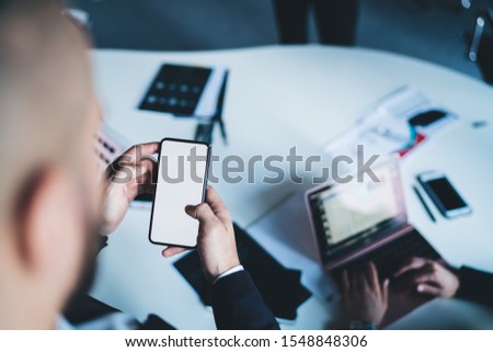 Image, Stock Photo Crop male entrepreneur browsing cellphone on street