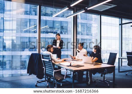 Professional financial experts collaborating during brainstorming meeting listening information from clever female director, businesswoman providing information to corporate workers of company
