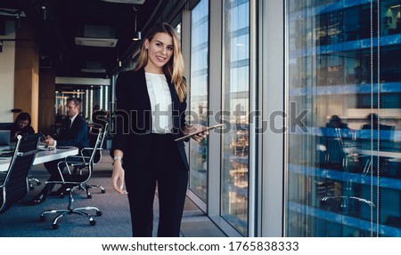 Similar – Image, Stock Photo Cheerful businesswoman browsing tablet in office