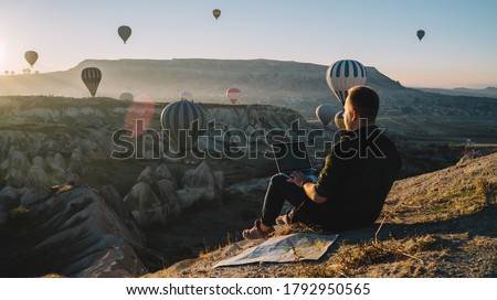 Similar – Image, Stock Photo Anonymous traveler on hill on misty day