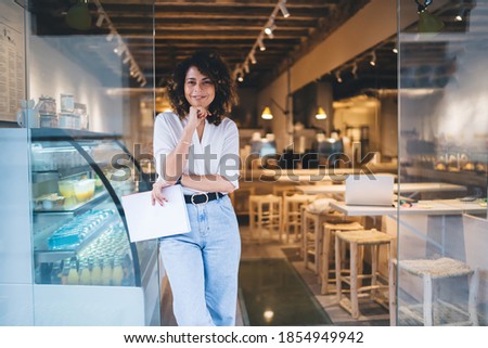 Half length of cheerful Caucaisan entrepreneur feeling success in franchise coffee shop standing in doorway and smiling at camera, happy self employed woman working in local cafeteria industry Сток-фото © 