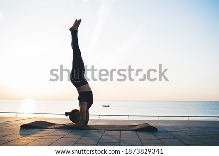 Similar – Image, Stock Photo Anonymous sportswoman practicing yoga on street