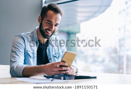 Similar – Image, Stock Photo Man browsing smartphone in office