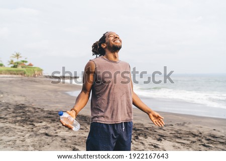 Similar – Image, Stock Photo Strong ethnic sportsman breathing during training on sports ground