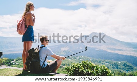 Similar – Image, Stock Photo Anonymous traveler admiring landscape of volcano under cloudy sky