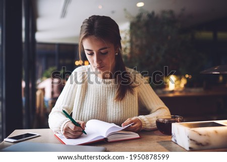 Similar – Image, Stock Photo Thoughtful woman taking notes in notebook in cafe