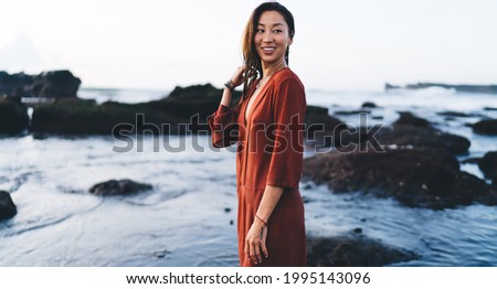 Similar – Image, Stock Photo Woman on stony seashore looking on foamy water washing peaks