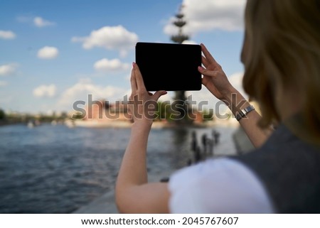 Female generation Z using blank touch pad device with copy space area for media advertising, back view of millennial tourist clicking image pictures or shooting video content on digital tablet Imagine de stoc © 