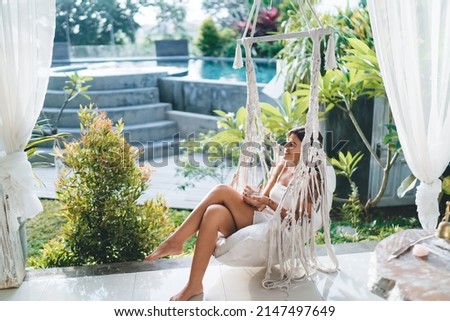 Similar – Image, Stock Photo beautiful caucasian woman sitting by pool side wearing bikini swimwear. Summer time, vacation and lifestyle