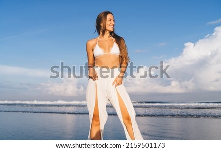 Image, Stock Photo A happy woman in nature. Portrait of a beautiful girl in close-up on the background of the lake. Young smiling woman outdoor portrait.