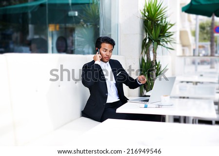 Asian businessman with angry expression on face talking on the smart phone, businessman having a phone talk, young man annoyed, frustrated, pissed off by someone listening on his mobile phone,bad news
