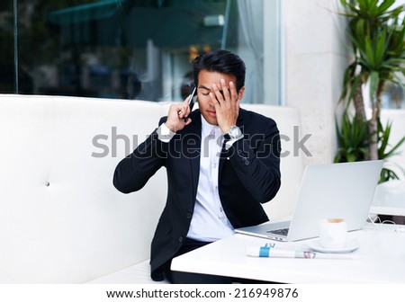 Surprised businessman listening bad news calling on smart phone, businessman having a phone talk, young man annoyed, frustrated, pissed off by someone listening on his mobile phone, bad news