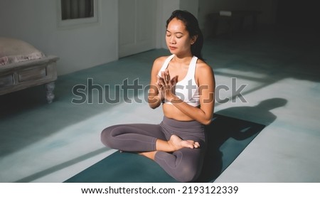 Similar – Image, Stock Photo Slim barefoot woman meditating in bound angle pose in contemporary workout room