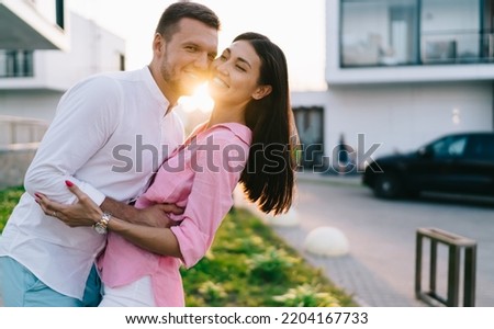 Image, Stock Photo Delighted couple hugging during sunset in nature
