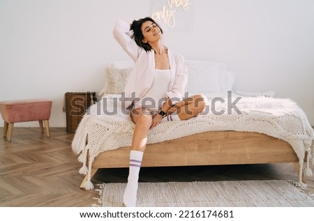 Similar – Image, Stock Photo Self assured young ethnic woman strolling on street in sunlight