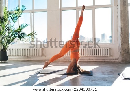 Similar – Image, Stock Photo Anonymous sportswoman practicing yoga on street