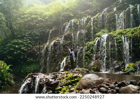 Similar – Image, Stock Photo Anonymous female tourist standing on rocky seashore and taking photos