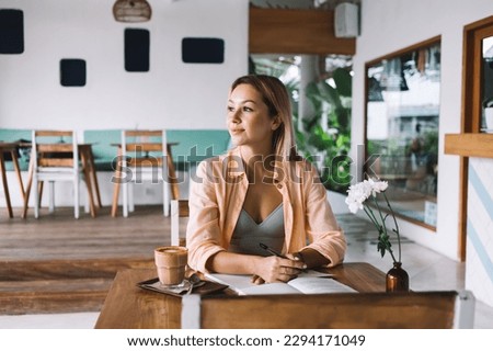 Similar – Image, Stock Photo Dreamy young lady drinking hot beverage near window with adorable weiro bird on shoulder