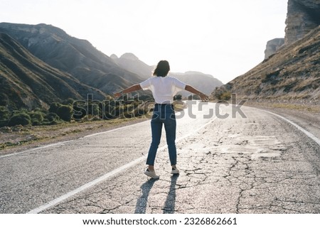 Similar – Image, Stock Photo Anonymous female tourist with trekking poles on meadow